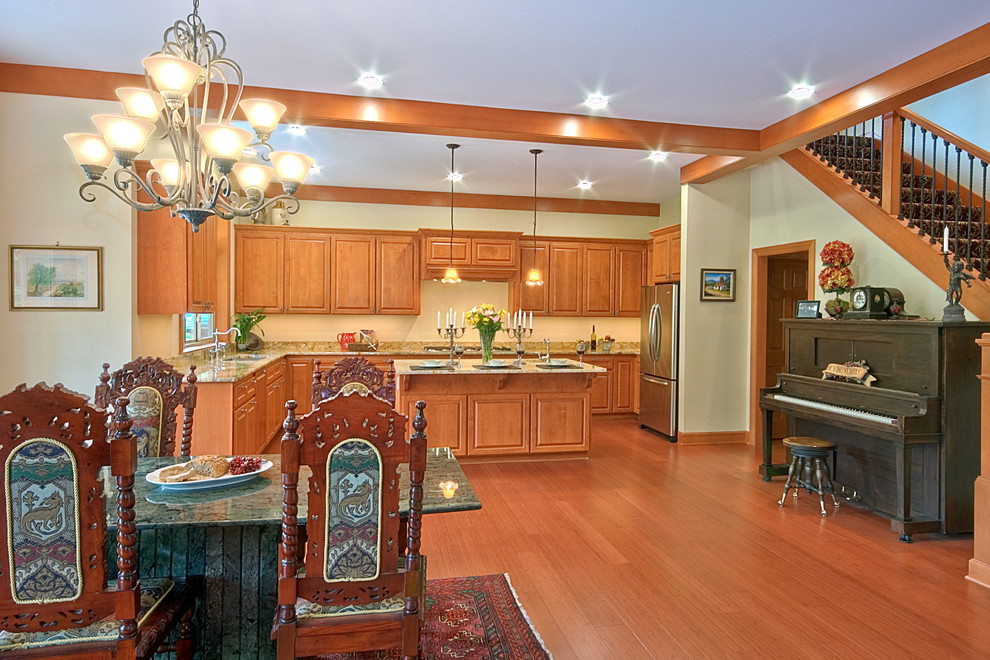 Inspiration for a large craftsman u-shaped medium tone wood floor and brown floor open concept kitchen remodel in Seattle with an undermount sink, medium tone wood cabinets, granite countertops, multicolored backsplash, stone slab backsplash, stainless steel appliances and an island