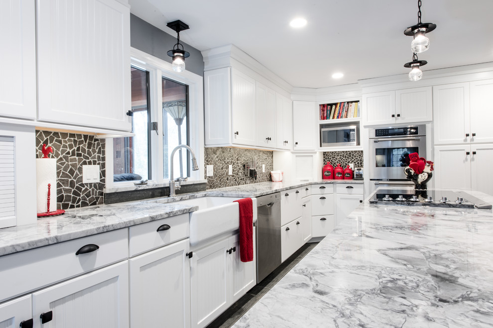 Inspiration for a large transitional u-shaped eat-in kitchen remodel in Providence with a farmhouse sink, white cabinets, granite countertops, stainless steel appliances, an island, beaded inset cabinets and stone tile backsplash