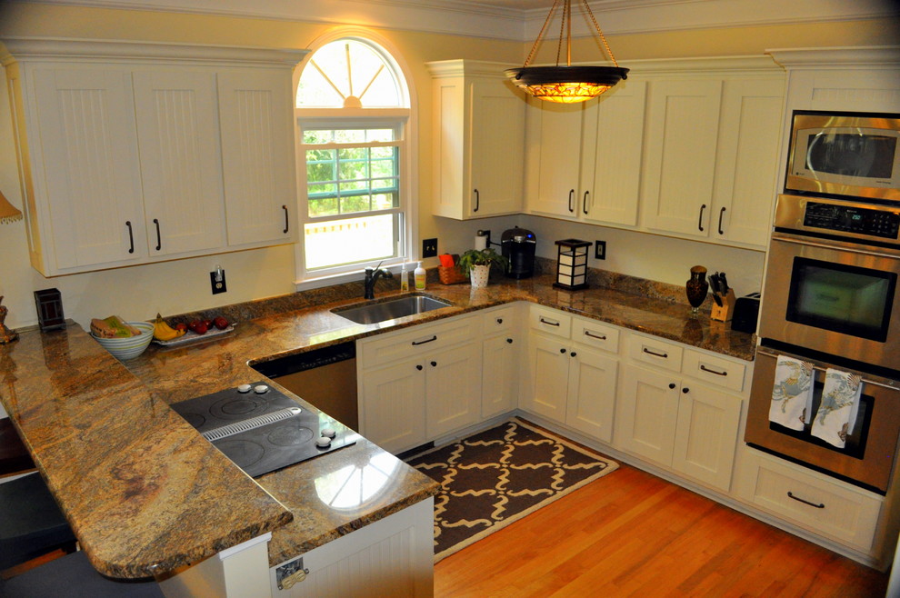 Design ideas for a contemporary u-shaped kitchen in Charleston with shaker cabinets and white cabinets.