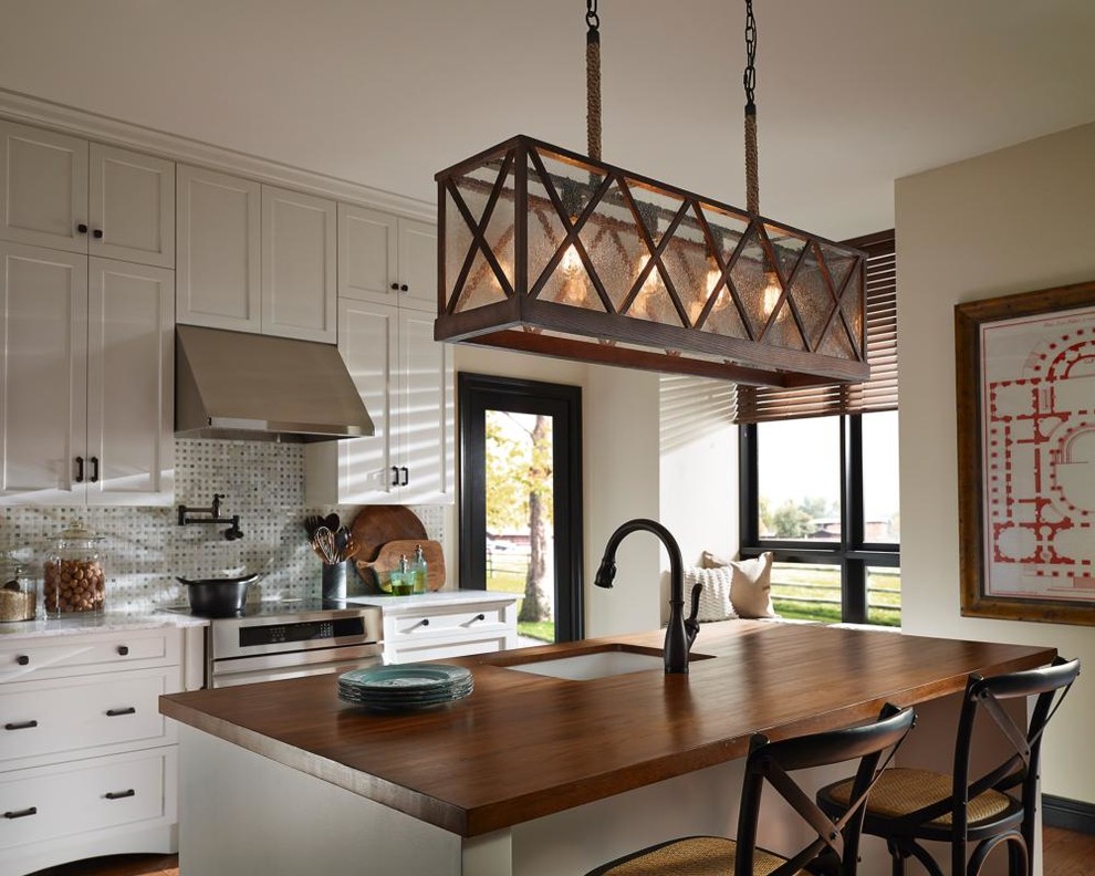 Exempel på ett avskilt, mellanstort rustikt l-kök, med en dubbel diskho, luckor med profilerade fronter, skåp i mellenmörkt trä, granitbänkskiva, vitt stänkskydd, stänkskydd i metallkakel, rostfria vitvaror och en köksö