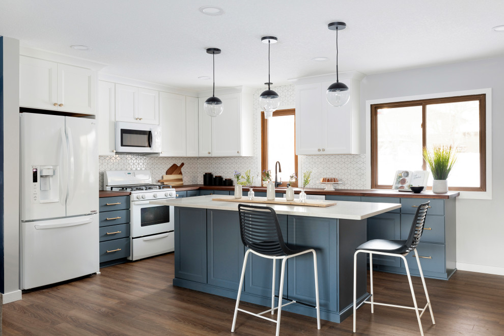 Inspiration for a large transitional l-shaped open concept kitchen remodel in Minneapolis with flat-panel cabinets, blue cabinets, wood countertops, white backsplash, mosaic tile backsplash, white appliances, an island and brown countertops
