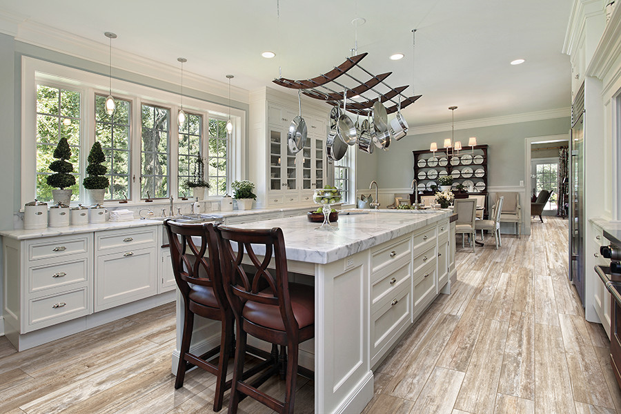Eat-in kitchen - large transitional u-shaped porcelain tile and beige floor eat-in kitchen idea in DC Metro with marble countertops, beaded inset cabinets, white cabinets, stainless steel appliances and an island