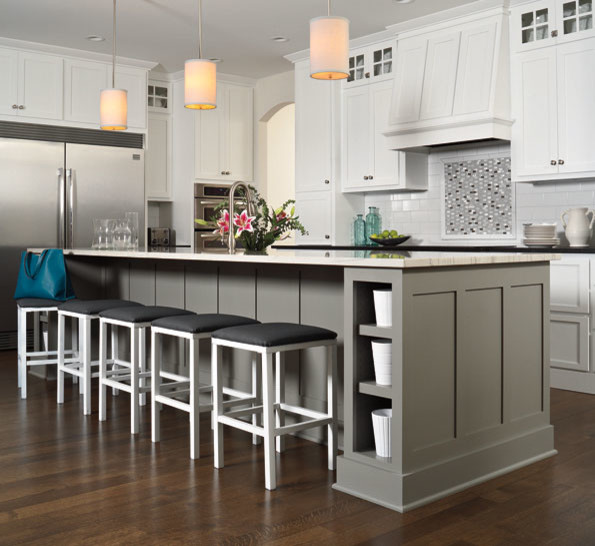 Mid-sized elegant l-shaped light wood floor and beige floor enclosed kitchen photo in Detroit with an undermount sink, recessed-panel cabinets, white cabinets, quartzite countertops, white backsplash, subway tile backsplash, stainless steel appliances and an island