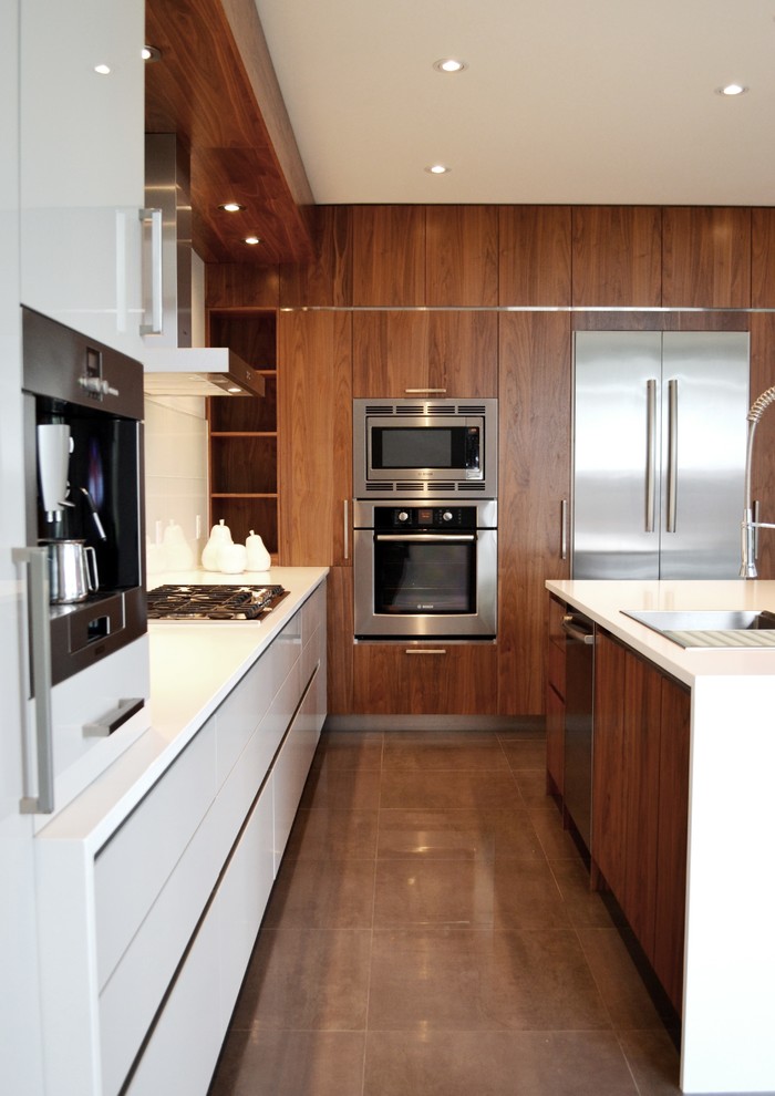 Eat-in kitchen - mid-sized contemporary single-wall eat-in kitchen idea in Ottawa with an undermount sink, flat-panel cabinets, white cabinets, solid surface countertops, white backsplash and an island