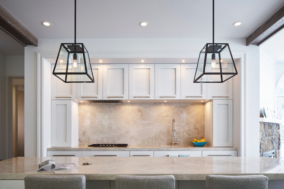 Inspiration for a large transitional l-shaped medium tone wood floor eat-in kitchen remodel in New York with an undermount sink, shaker cabinets, white cabinets, quartzite countertops, gray backsplash, stone slab backsplash, stainless steel appliances and an island
