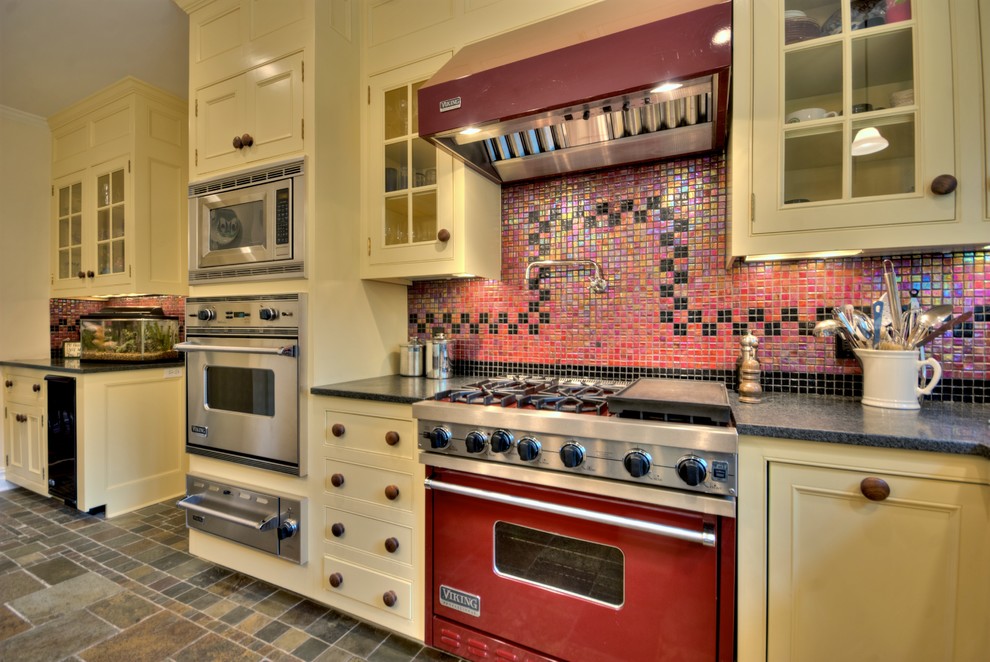 Inspiration for a mid-sized timeless l-shaped slate floor and multicolored floor eat-in kitchen remodel in New York with an undermount sink, recessed-panel cabinets, white cabinets, granite countertops, red backsplash, mosaic tile backsplash, stainless steel appliances and an island