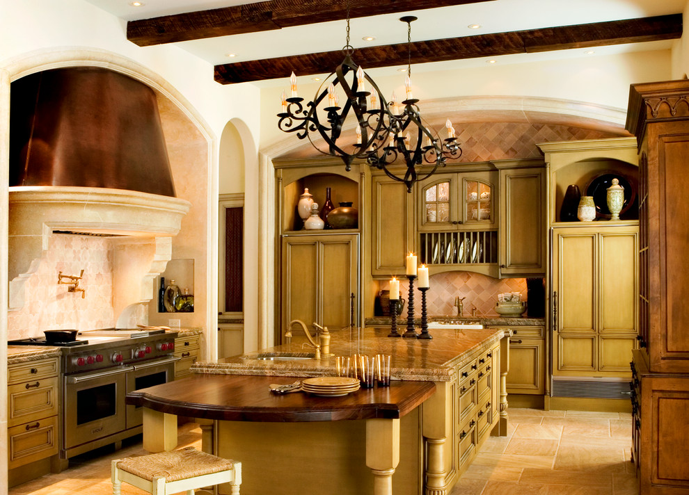 Eat-in kitchen - mid-sized traditional u-shaped travertine floor eat-in kitchen idea in Atlanta with a farmhouse sink, raised-panel cabinets, green cabinets, granite countertops, white backsplash, stone tile backsplash, stainless steel appliances and an island
