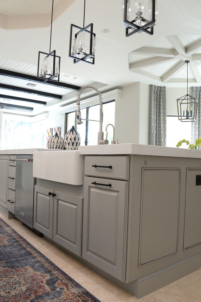 Inspiration for a large modern travertine floor and beige floor eat-in kitchen remodel in Phoenix with a farmhouse sink, raised-panel cabinets, white cabinets, quartz countertops, gray backsplash, brick backsplash, stainless steel appliances, two islands and white countertops