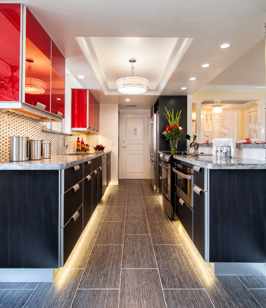 Kitchen - mid-sized contemporary galley porcelain tile kitchen idea in Miami with an undermount sink, granite countertops, white backsplash, glass tile backsplash, stainless steel appliances, red cabinets, no island and flat-panel cabinets