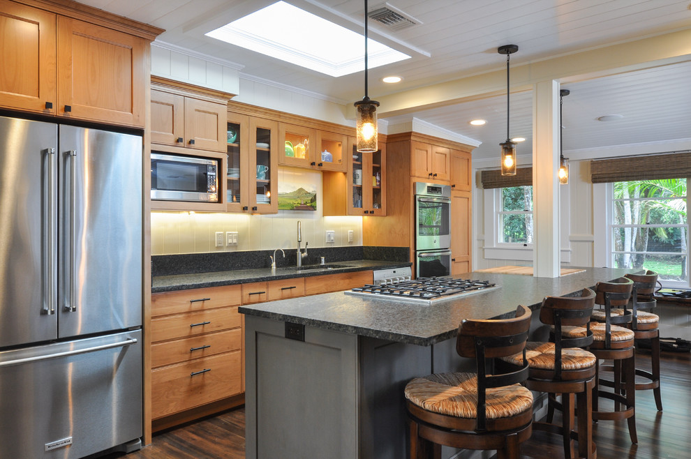Example of a mid-sized transitional galley dark wood floor and brown floor open concept kitchen design with an undermount sink, shaker cabinets, granite countertops, black backsplash, stone slab backsplash, stainless steel appliances, an island and medium tone wood cabinets