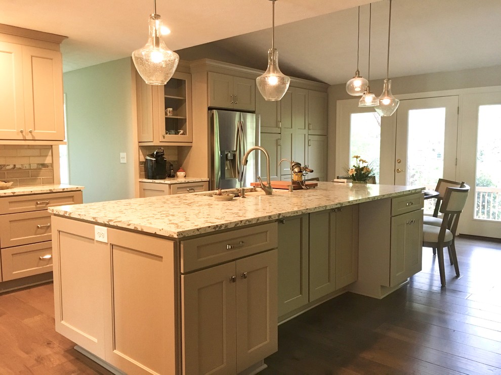 Eat-in kitchen - large transitional l-shaped medium tone wood floor eat-in kitchen idea in Atlanta with a single-bowl sink, shaker cabinets, beige cabinets, quartz countertops, multicolored backsplash, glass tile backsplash, stainless steel appliances and an island