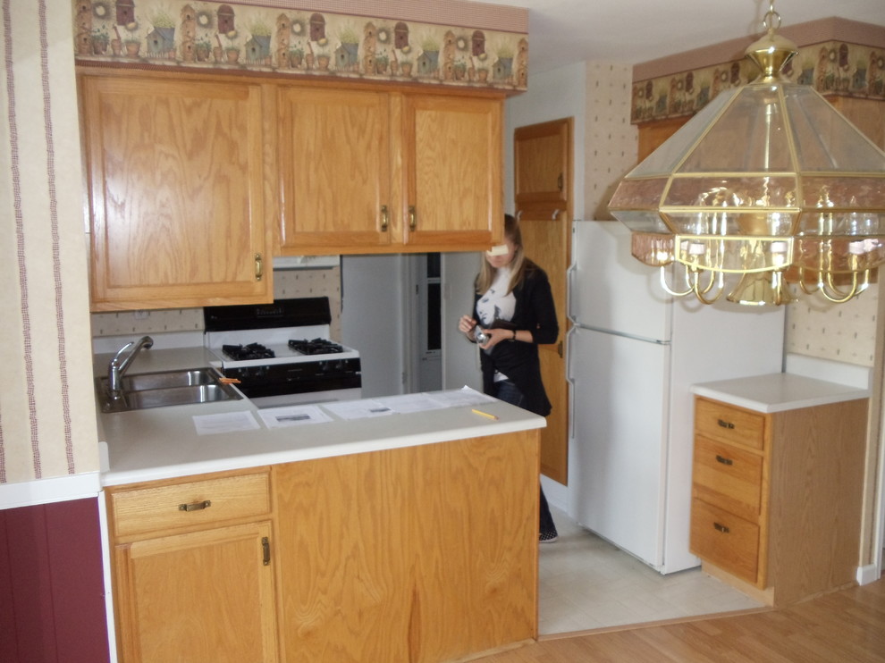 Small modern u-shaped kitchen in Grand Rapids with a double-bowl sink, raised-panel cabinets, medium wood cabinets, laminate countertops, beige splashback, lino flooring and no island.