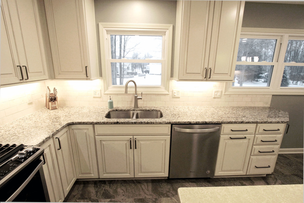 Beige Kitchen with Extra Large Island, Tile Backsplash and Granite