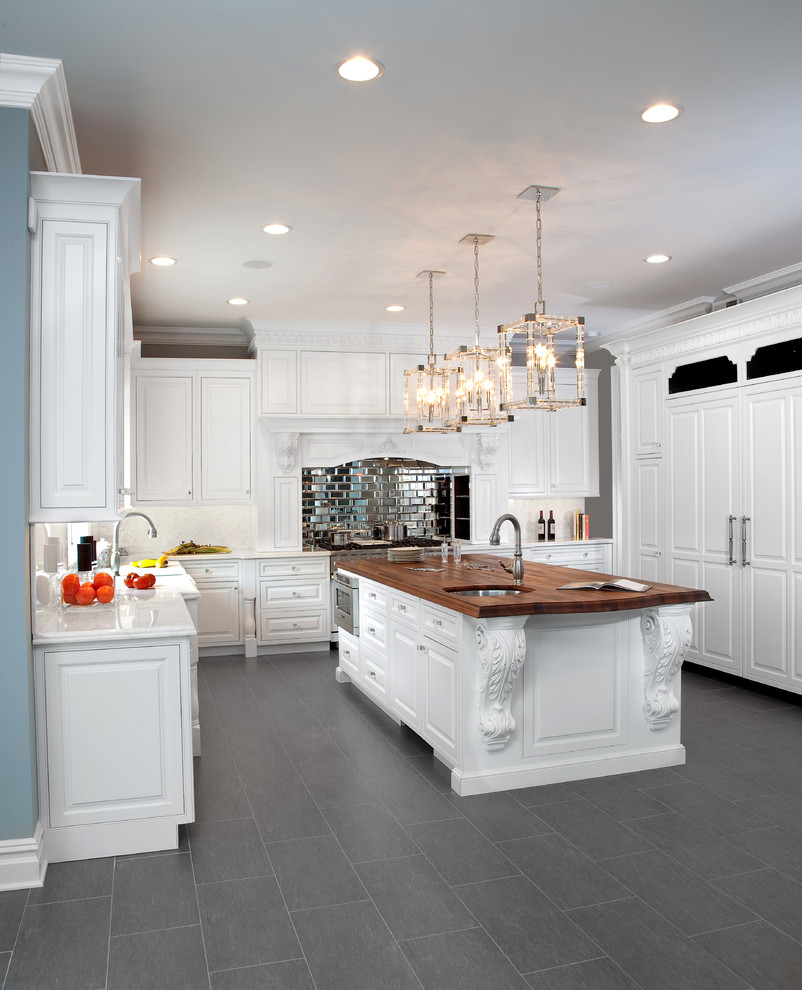 Eat-in kitchen - large traditional u-shaped porcelain tile eat-in kitchen idea in New York with a farmhouse sink, beaded inset cabinets, white cabinets, marble countertops, white backsplash, stone tile backsplash, paneled appliances and an island
