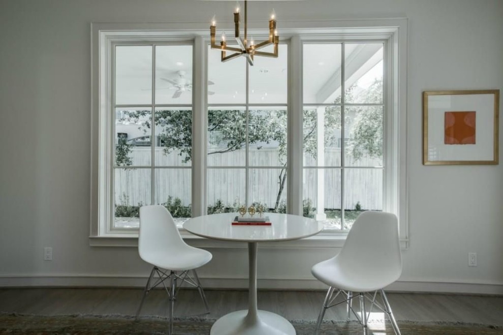 Inspiration for a medium sized classic enclosed dining room in Dallas with light hardwood flooring and brown floors.