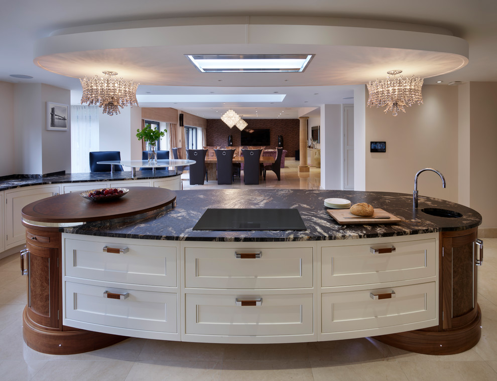 Example of a huge trendy open concept kitchen design in London with granite countertops, black backsplash, glass sheet backsplash, stainless steel appliances and an island