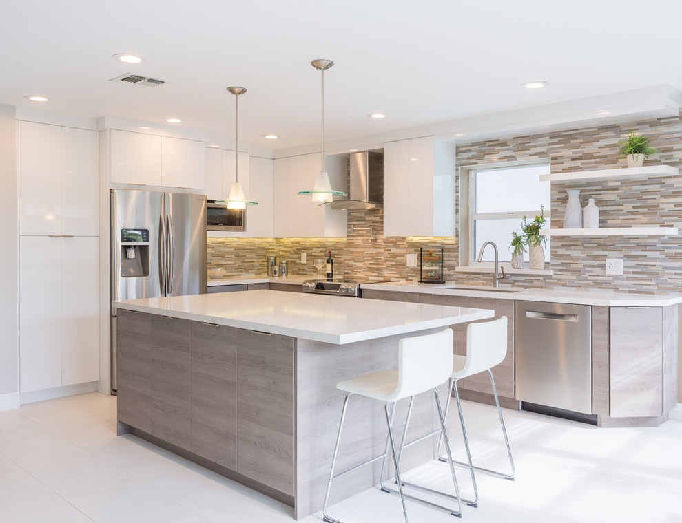 Inspiration for a mid-sized contemporary l-shaped porcelain tile open concept kitchen remodel in Miami with an undermount sink, flat-panel cabinets, white cabinets, quartz countertops, multicolored backsplash, mosaic tile backsplash, stainless steel appliances and an island