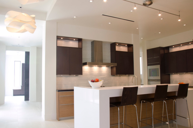 Eat-in kitchen - large contemporary porcelain tile and white floor eat-in kitchen idea in Houston with an undermount sink, flat-panel cabinets, medium tone wood cabinets, quartz countertops, white backsplash, glass tile backsplash, stainless steel appliances and an island