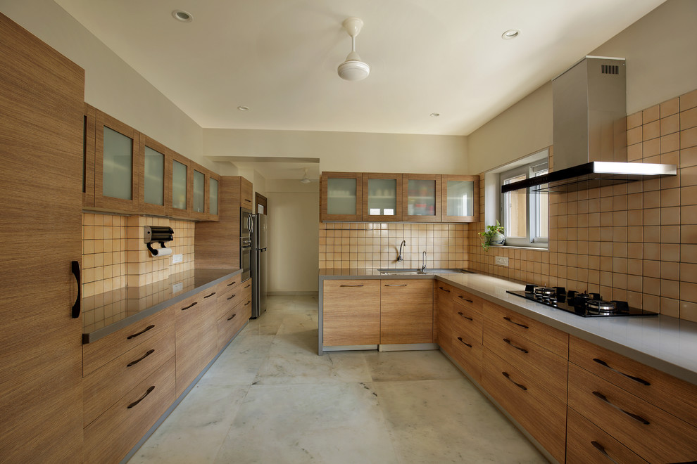 Photo of a contemporary u-shaped kitchen in Ahmedabad with a double-bowl sink, glass-front cabinets, medium wood cabinets, beige splashback, no island, grey floors and grey worktops.