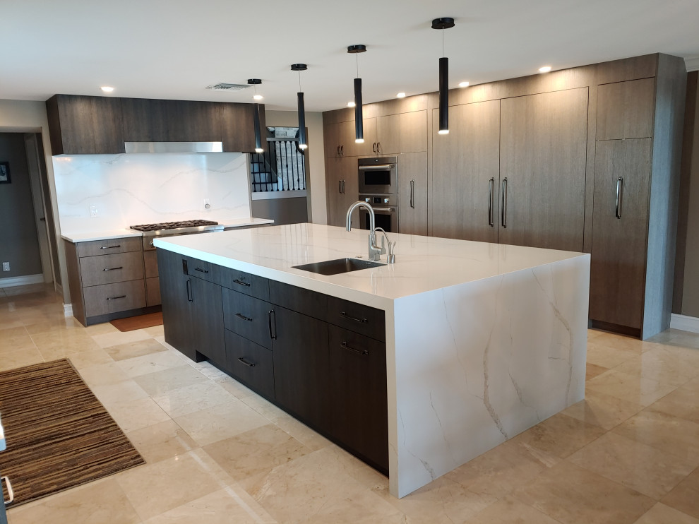 Example of a large minimalist u-shaped travertine floor and beige floor open concept kitchen design in Tampa with a single-bowl sink, flat-panel cabinets, gray cabinets, quartz countertops, white backsplash, quartz backsplash, paneled appliances, an island and white countertops