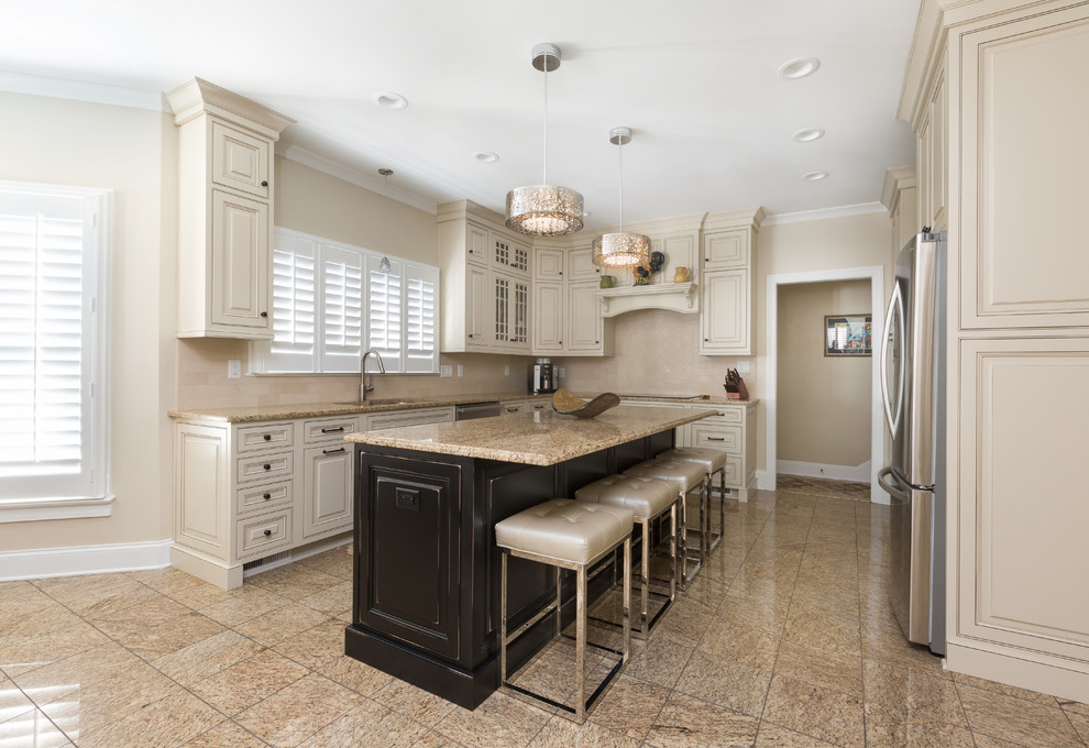 This is an example of a medium sized modern l-shaped kitchen with a submerged sink, shaker cabinets, white cabinets, granite worktops, beige splashback, stainless steel appliances, an island and beige floors.