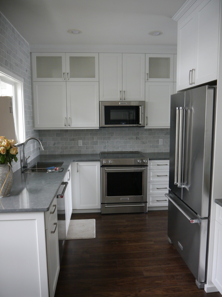 Idéer för att renovera ett mellanstort vintage grå grått kök och matrum, med en nedsänkt diskho, skåp i shakerstil, vita skåp, bänkskiva i koppar, grått stänkskydd, stänkskydd i marmor, rostfria vitvaror, vinylgolv och brunt golv