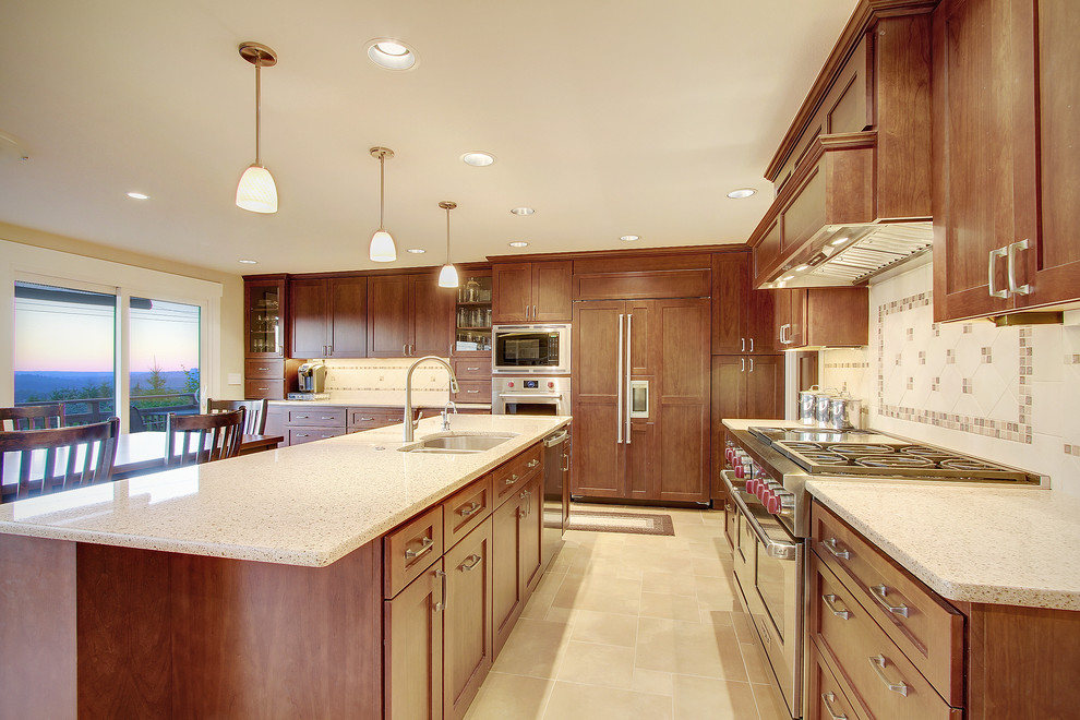 Example of a huge transitional galley light wood floor open concept kitchen design in Seattle with an undermount sink, shaker cabinets, medium tone wood cabinets, quartzite countertops, multicolored backsplash, porcelain backsplash, stainless steel appliances and an island