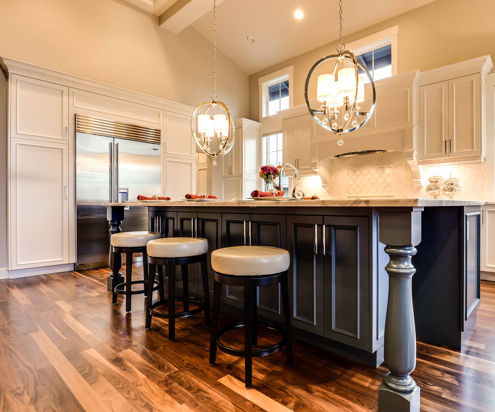 Expansive modern u-shaped kitchen pantry in Seattle with a double-bowl sink, marble worktops, stainless steel appliances, dark hardwood flooring, an island, multi-coloured floors and white worktops.