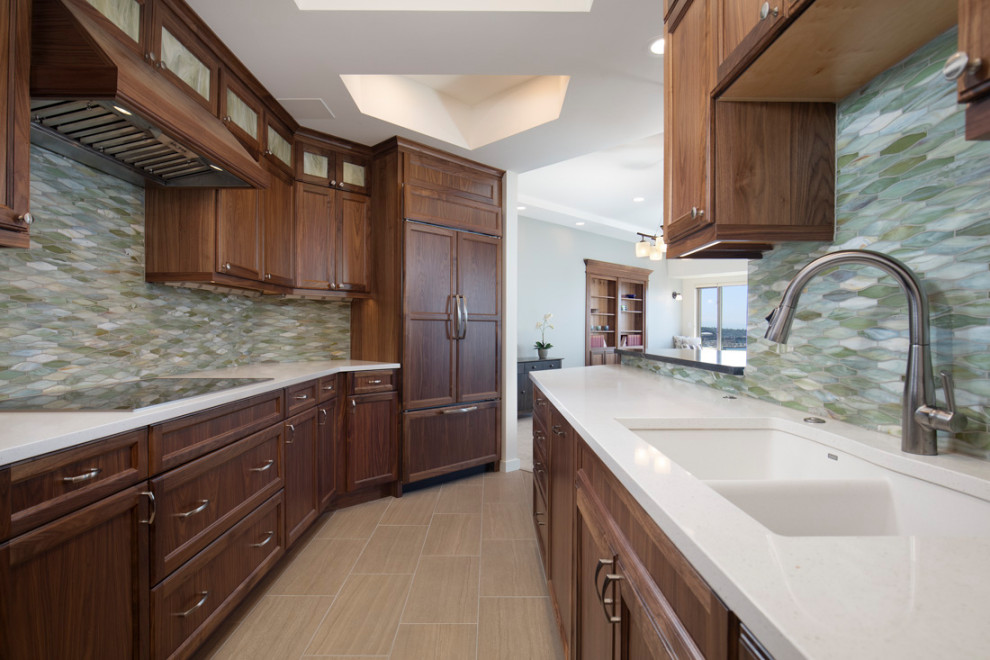 Inspiration for a mid-sized timeless galley porcelain tile and beige floor open concept kitchen remodel in Seattle with an undermount sink, shaker cabinets, brown cabinets, quartzite countertops, multicolored backsplash, glass tile backsplash, paneled appliances, no island and white countertops