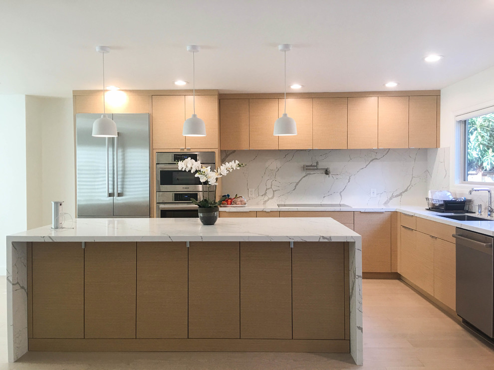 Photo of a large modern l-shaped open plan kitchen in San Francisco with a submerged sink, flat-panel cabinets, engineered stone countertops, white splashback, stone slab splashback, stainless steel appliances, light hardwood flooring, an island, beige floors, white worktops and light wood cabinets.