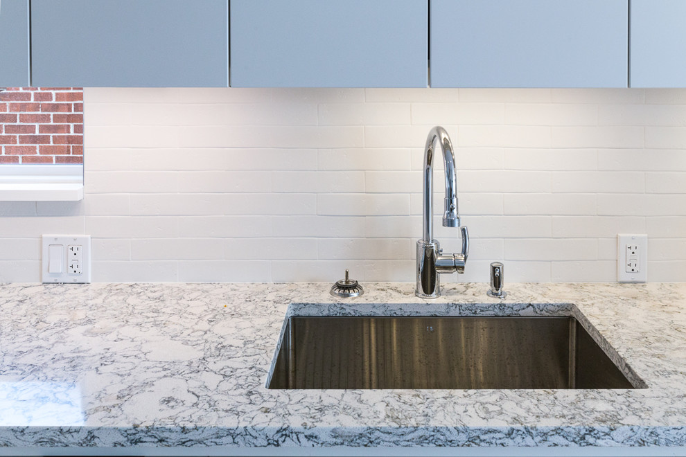 Kitchen - large contemporary kitchen idea in Ottawa with an undermount sink, quartz countertops, white backsplash and subway tile backsplash