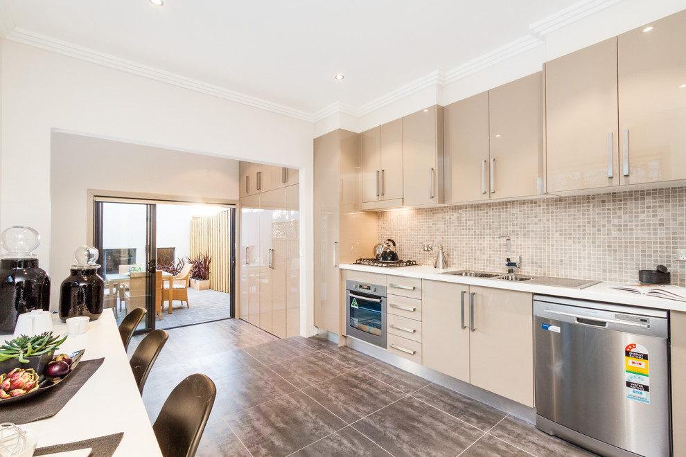 Design ideas for a contemporary kitchen in Sydney with a double-bowl sink, flat-panel cabinets, beige cabinets, granite worktops, beige splashback, ceramic splashback, stainless steel appliances and no island.