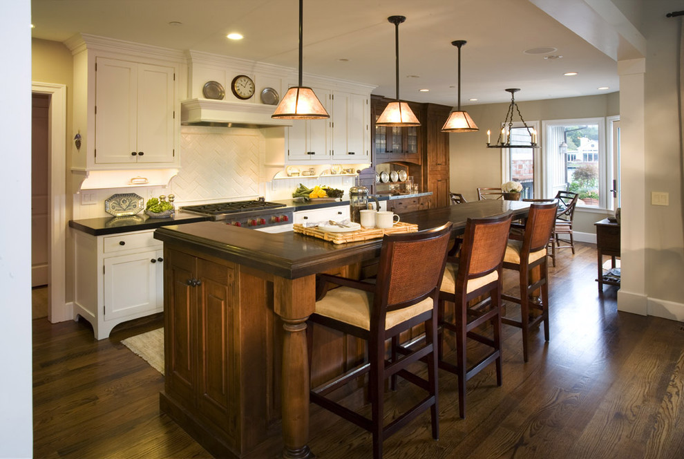 Elegant kitchen photo in San Francisco with white backsplash and an island