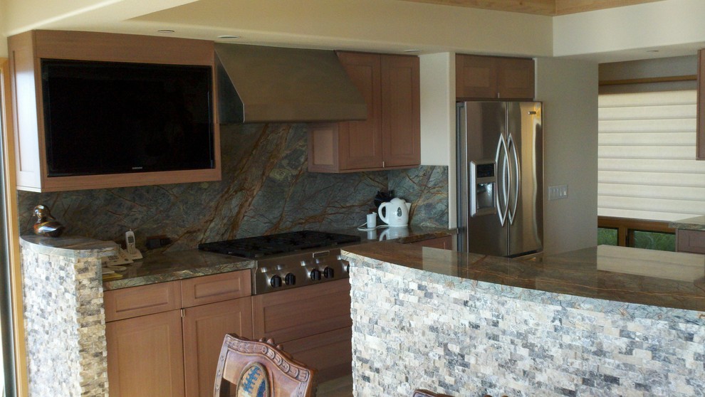 This is an example of a contemporary u-shaped kitchen/diner in Seattle with a submerged sink, shaker cabinets, medium wood cabinets, granite worktops, green splashback and stainless steel appliances.