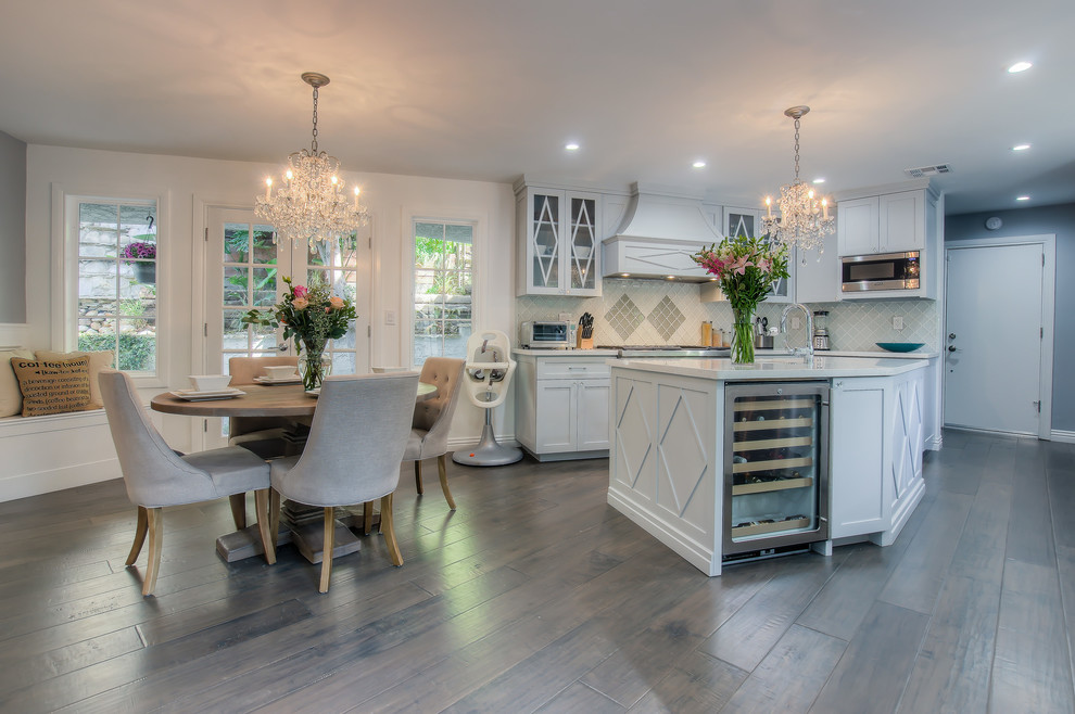 Open concept kitchen - transitional galley open concept kitchen idea in Los Angeles with shaker cabinets, glass tile backsplash, stainless steel appliances, an island, white cabinets and gray backsplash