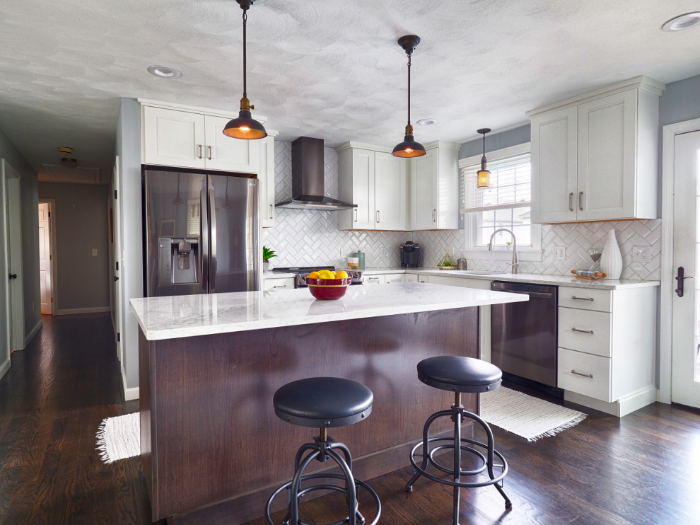 Example of a small classic l-shaped dark wood floor eat-in kitchen design in Providence with an undermount sink, recessed-panel cabinets, white cabinets, quartz countertops, white backsplash, subway tile backsplash, stainless steel appliances, an island and white countertops