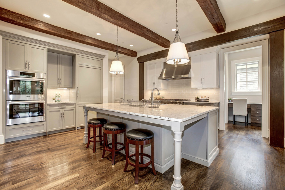 Large arts and crafts galley medium tone wood floor eat-in kitchen photo in DC Metro with a drop-in sink, raised-panel cabinets, white cabinets, granite countertops, white backsplash, stainless steel appliances and an island