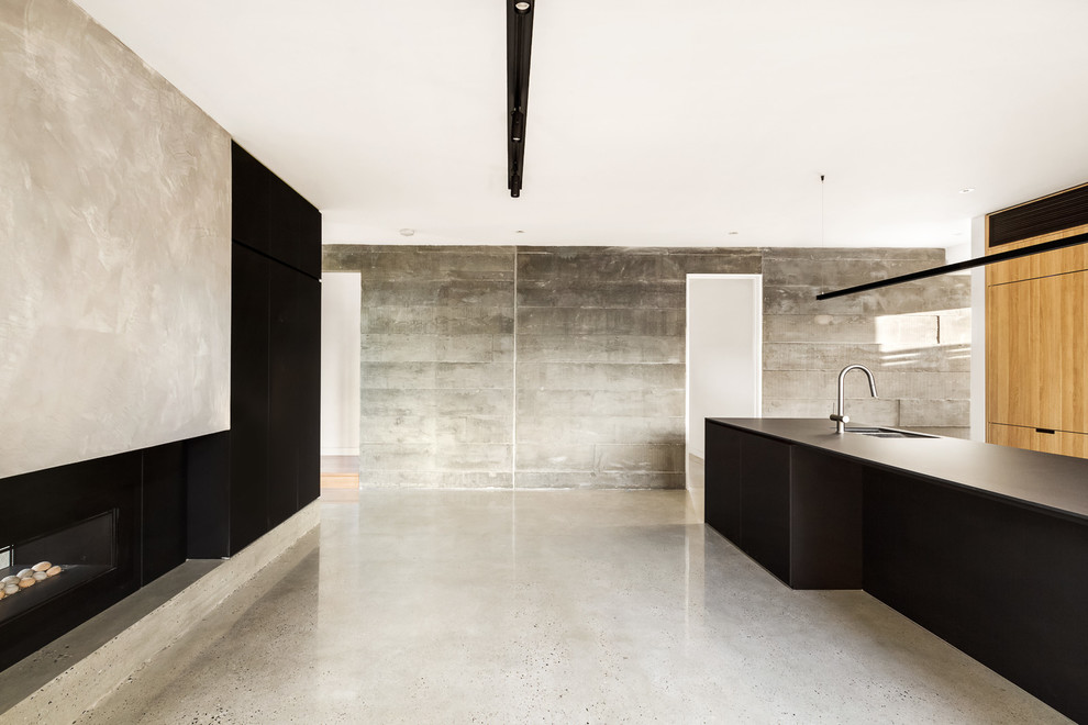 Example of a huge minimalist concrete floor and gray floor eat-in kitchen design in Melbourne with an undermount sink, laminate countertops and an island