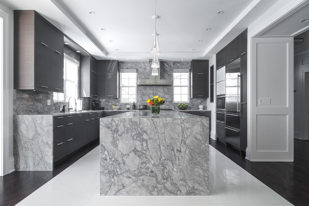 Inspiration for a large contemporary u-shaped dark wood floor and brown floor kitchen remodel in Los Angeles with an undermount sink, flat-panel cabinets, gray cabinets, marble countertops, gray backsplash, stone slab backsplash, stainless steel appliances and an island