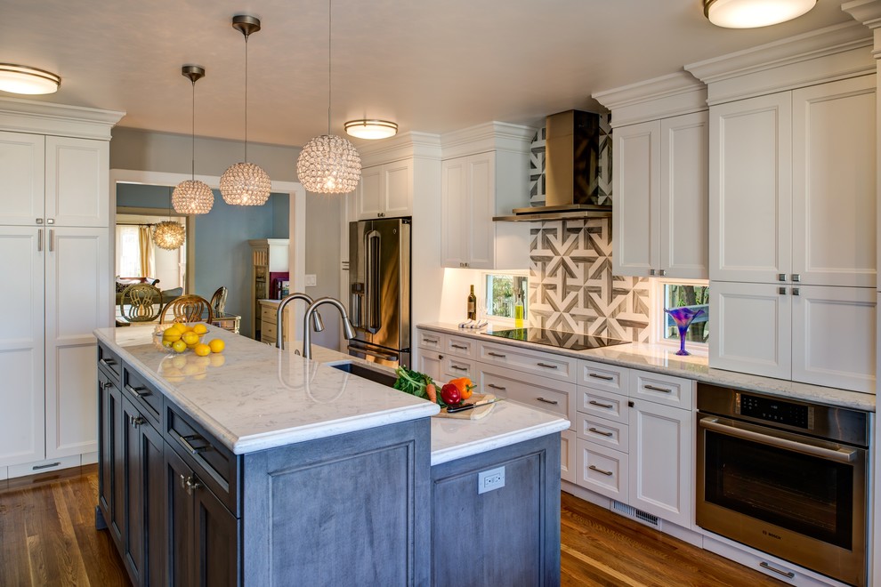 Eat-in kitchen - large traditional single-wall light wood floor and beige floor eat-in kitchen idea in San Francisco with an undermount sink, recessed-panel cabinets, white cabinets, granite countertops, brown backsplash, ceramic backsplash, stainless steel appliances and an island