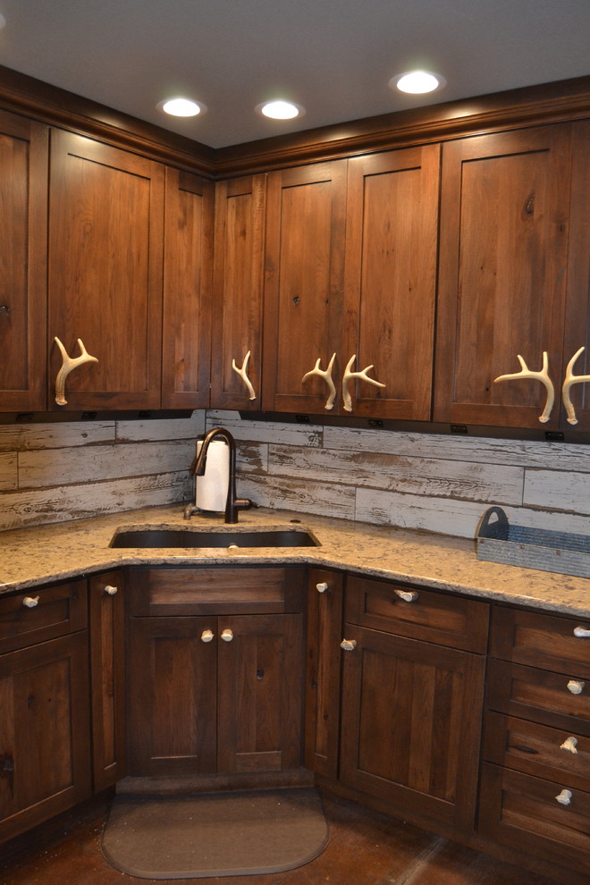 Example of a mid-sized mountain style l-shaped concrete floor and brown floor open concept kitchen design in Other with an undermount sink, recessed-panel cabinets, dark wood cabinets, quartz countertops, multicolored backsplash, ceramic backsplash, white appliances and an island