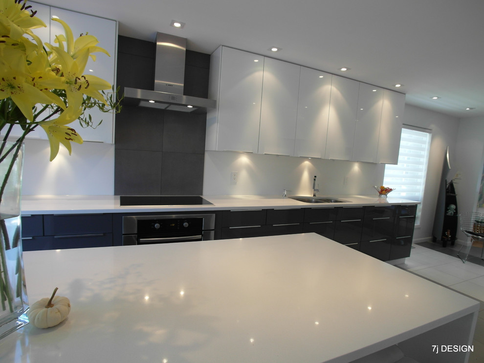 Medium sized modern galley open plan kitchen in Ottawa with a double-bowl sink, flat-panel cabinets, white cabinets, engineered stone countertops, white splashback, stainless steel appliances, ceramic flooring and an island.