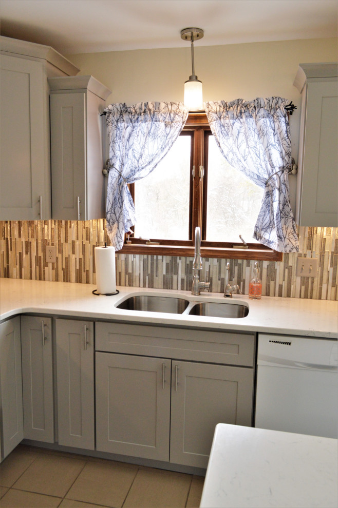 Mid-sized transitional l-shaped ceramic tile and beige floor eat-in kitchen photo in Other with an undermount sink, shaker cabinets, gray cabinets, quartzite countertops, multicolored backsplash, matchstick tile backsplash, white appliances, an island and white countertops