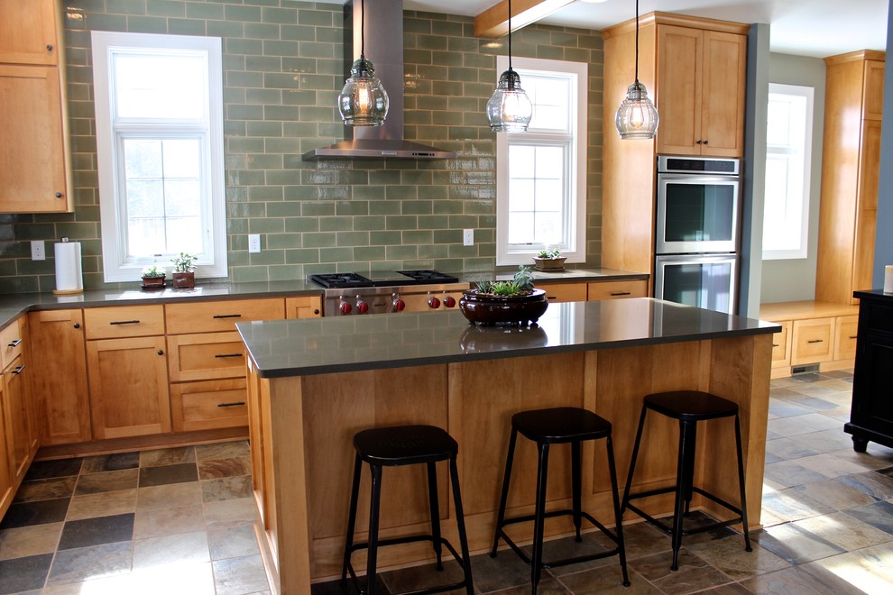 Mid-sized minimalist l-shaped ceramic tile open concept kitchen photo in Milwaukee with recessed-panel cabinets, light wood cabinets, quartz countertops, green backsplash, subway tile backsplash, stainless steel appliances and an island