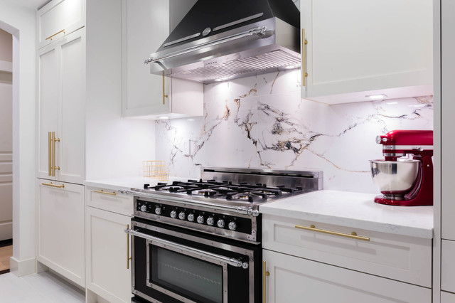 Bertazzoni appliances in a White and gold kitchen with Marble