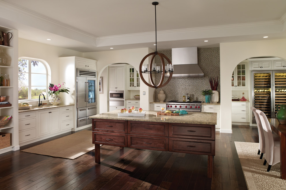 Inspiration for a large timeless l-shaped dark wood floor open concept kitchen remodel in Cleveland with an undermount sink, shaker cabinets, white cabinets, granite countertops, multicolored backsplash, mosaic tile backsplash, stainless steel appliances and an island