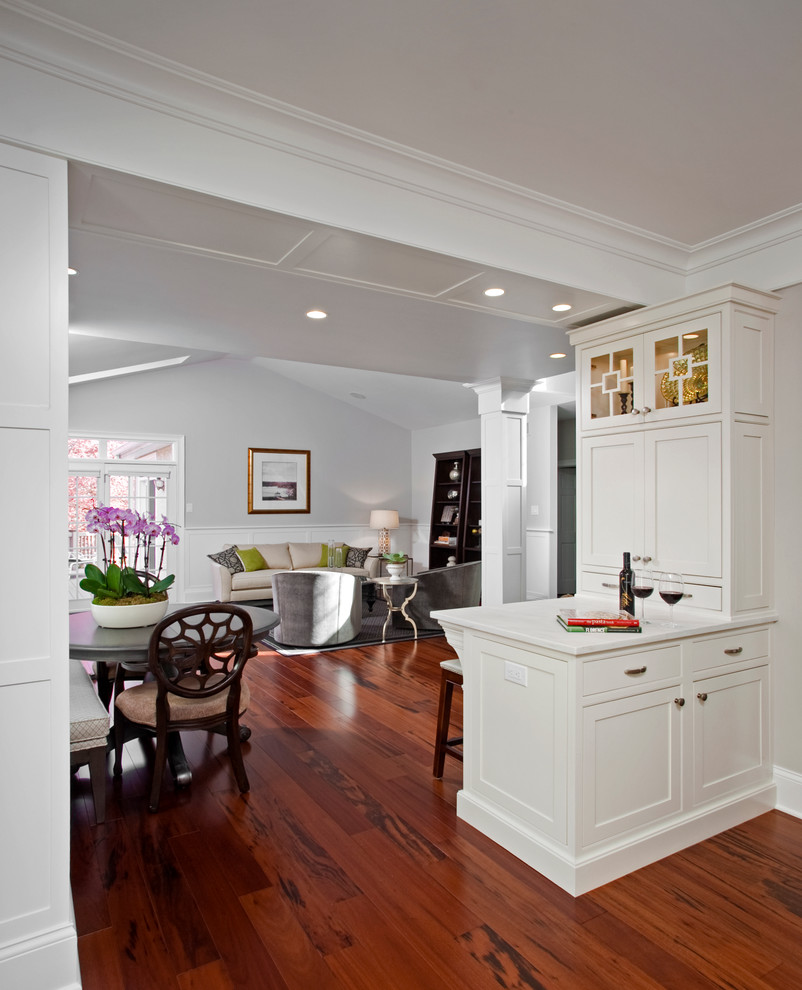 Inspiration for a large transitional u-shaped medium tone wood floor and beige floor eat-in kitchen remodel in Philadelphia with an undermount sink, beaded inset cabinets, white cabinets, marble countertops, white backsplash, subway tile backsplash, stainless steel appliances and a peninsula