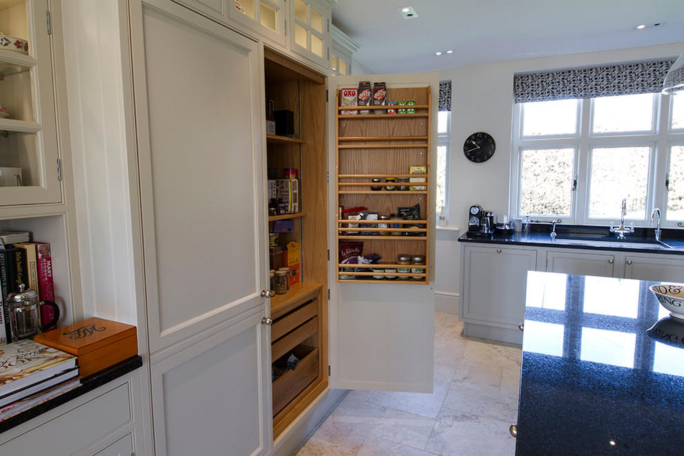 Inspiration for a large traditional grey and cream u-shaped kitchen pantry in Buckinghamshire with a double-bowl sink, recessed-panel cabinets, grey cabinets, granite worktops, white splashback, ceramic splashback, black appliances, limestone flooring and an island.