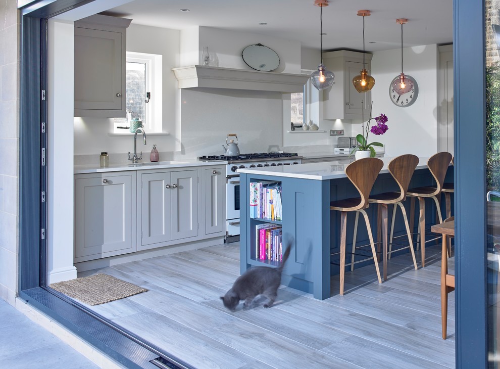 Mid-sized transitional single-wall porcelain tile and gray floor eat-in kitchen photo in Other with quartzite countertops, an island, an undermount sink, shaker cabinets, gray cabinets, white backsplash, stainless steel appliances and white countertops