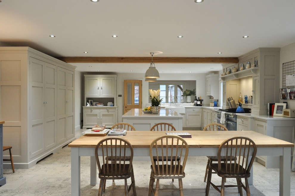 Inspiration for an expansive traditional l-shaped open plan kitchen in Other with a belfast sink, shaker cabinets, grey cabinets, quartz worktops, coloured appliances, limestone flooring and an island.